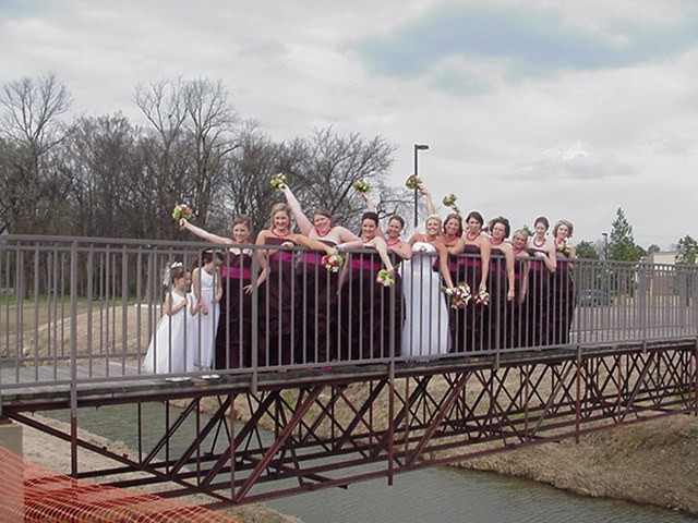 Bridesmaids on foot bridge